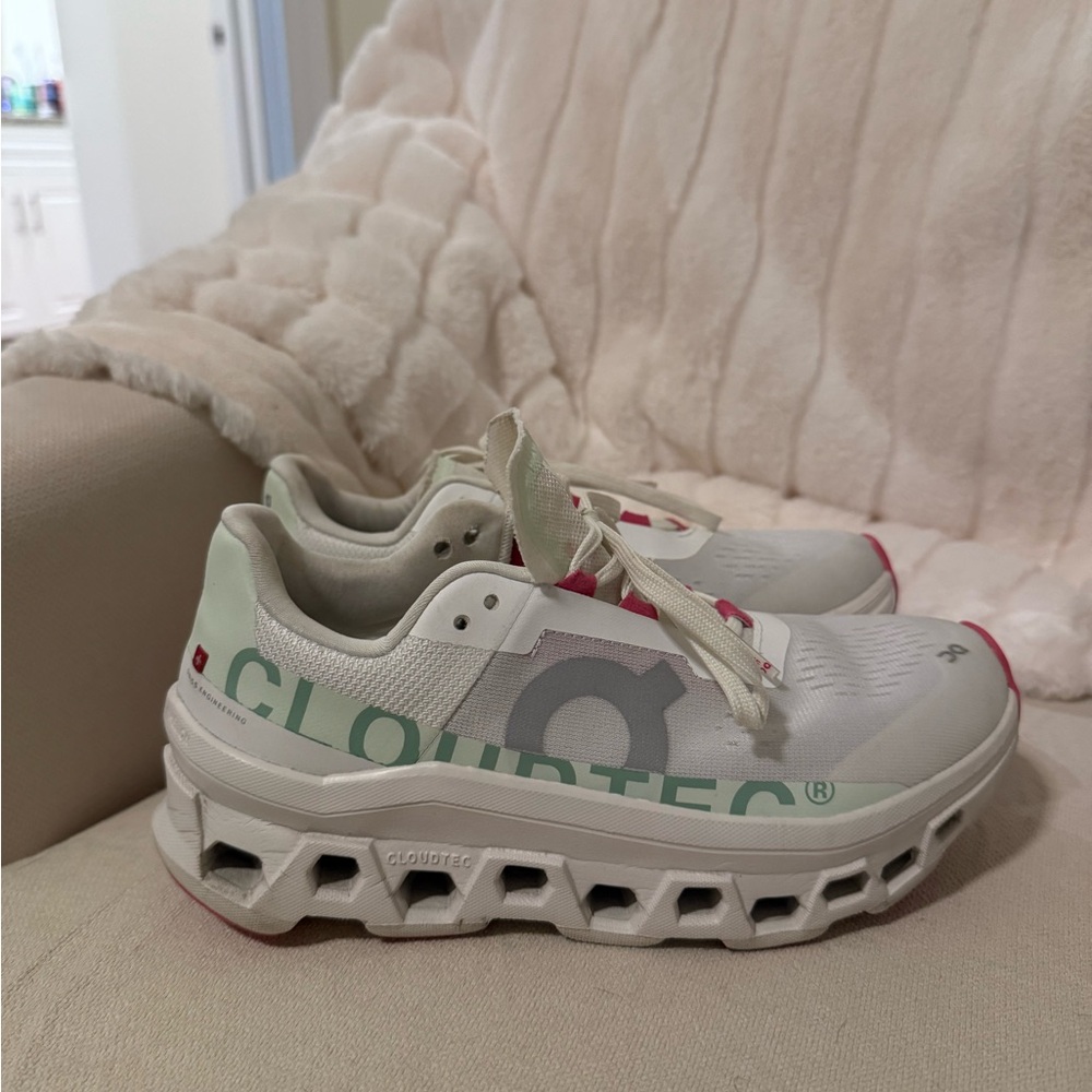 On Cloudtec cream color with pink and green accents